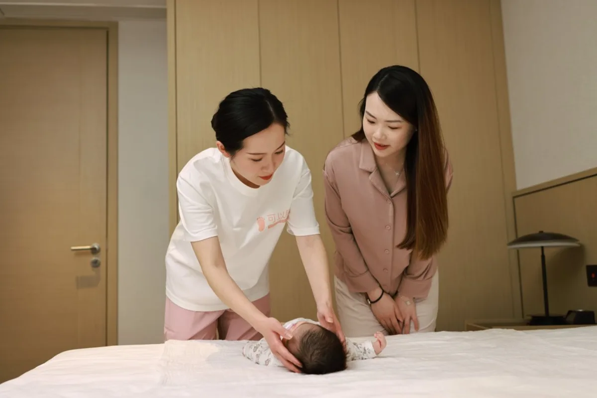 Cooings doula caring for a newborn with mother